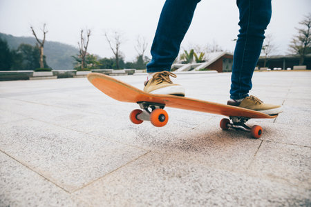Skateboarder skateboarding outdoors on sunny morningの写真素材