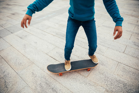 Asian woman skateboarder skateboarding in modern cityの写真素材