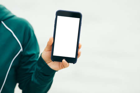 Asian woman using smartphone outdoorsの写真素材