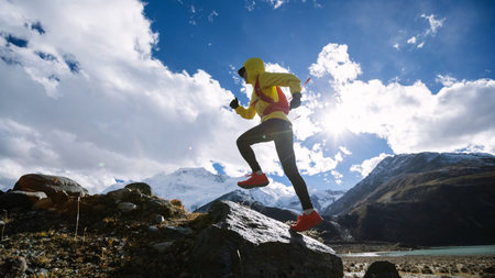 Woman trail runner cross country running in high altitude winter nature