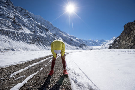 Woman trail runner cross country running  in winter mountains