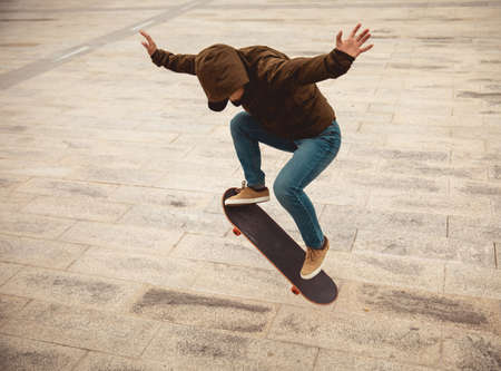 Asian woman skateboarder skateboarding in modern cityの写真素材