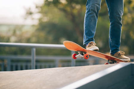 Asian woman skateboarder skateboarding at skateparkの写真素材
