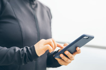 Asian woman using smartphone outdoors