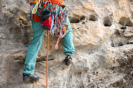 Woman rock climber climbing on the cliff