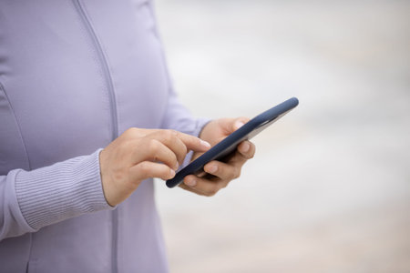 Asian woman using smartphone outdoors