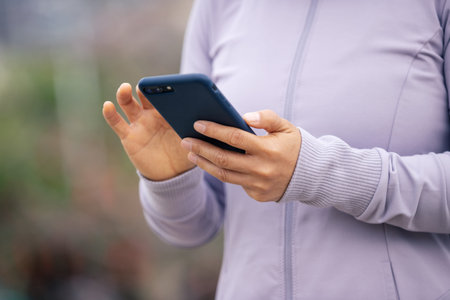 Asian woman skateboarder skateboarding in modern cityの写真素材