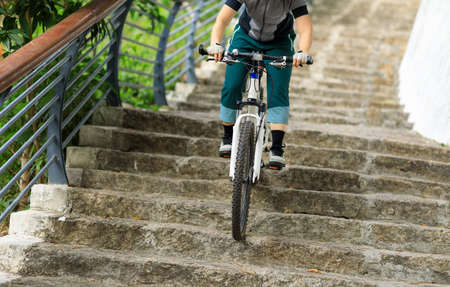 Woman freerider riding down stairs. Sports extreme and active lifestyleの写真素材