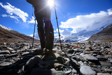 Woman hiker hiking in high altitude winter mountainsの写真素材