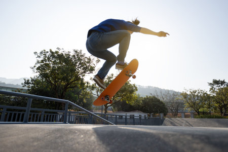 Asian woman skateboarder skateboarding at skatepark