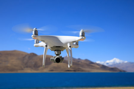 Flying drone taking photo of  landscape in yamdrok lake in tibet chinaの写真素材