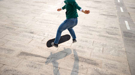 Woman skateboarder skateboarding at outdoorsの写真素材