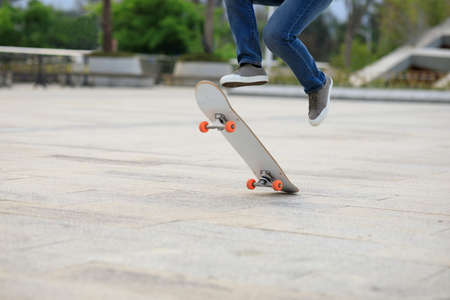 Asian woman skateboarder skateboarding in modern cityの写真素材