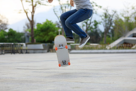 Asian woman skateboarder skateboarding in modern city