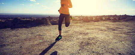 Fitness woman trail runner cross country running on sand desert