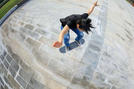 Skateboarder skateboarding outdoors in the morningの写真素材