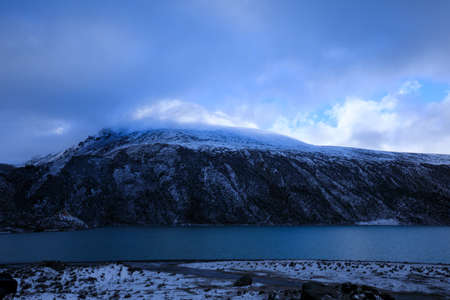 Snowing high altitude mountains on winter day