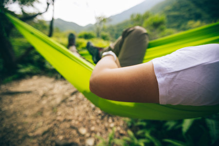 Relaxing in hammock in tropical forest