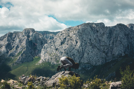 Hiker have fun on high altitude moutnain top cliff edge
