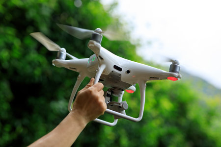 Hand hold drone in summer mountainsの写真素材
