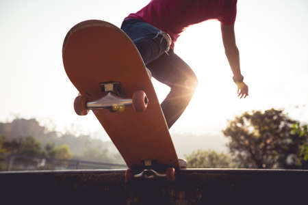 Asian woman skateboarder skateboarding at skateparkの写真素材
