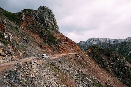 Driving off road car on high altitude mountain topの写真素材
