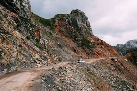 Driving off road car on high altitude mountain topの写真素材