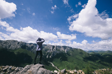 Hiker on high altitude mountain topの写真素材