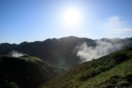 Arising fog nature mist mountains magic high altitude sunrise landscapeの写真素材