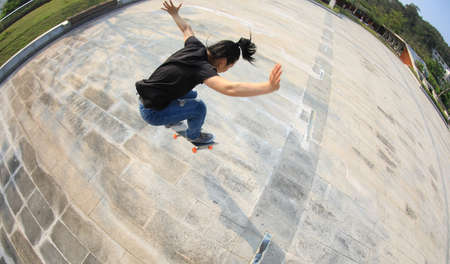 Skateboarder skateboarding outdoors in cityの写真素材