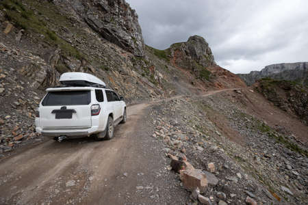 Driving off road car on high altitude mountain topの写真素材