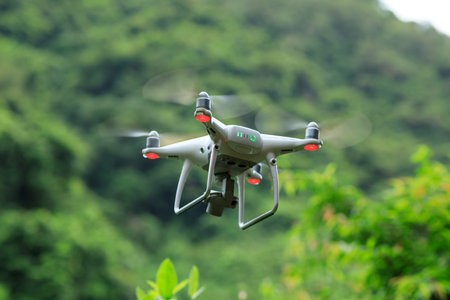 White drone with camera flying in summer mountainsの写真素材