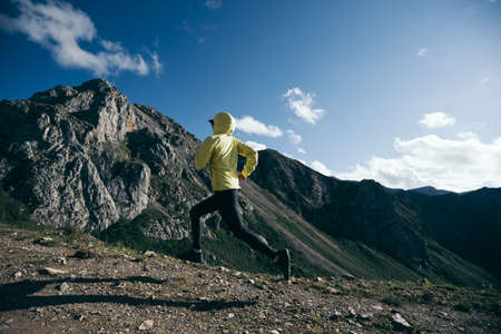 Woman runner running at mountain topの写真素材