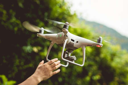 Hand hold drone in summer mountainsの写真素材