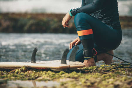 Woman surfer with surfboard on seasideの写真素材