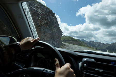 Driving off-road car on a high altitude mountain topの写真素材