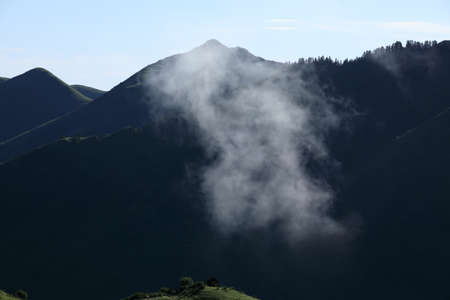Arising fog nature mist mountains magic high altitude sunrise landscapeの写真素材