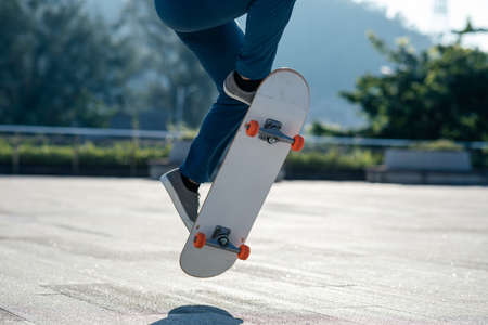 Skateboarder skateboarding outdoors in cityの写真素材