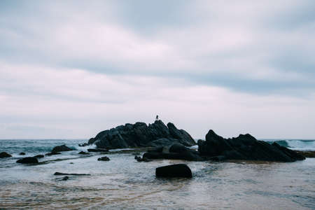 Woman  stand in the  cliff edge at seasideの写真素材