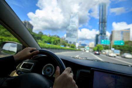 Driving car in modern cityの写真素材