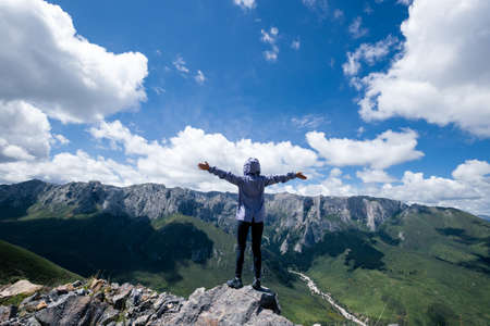 Successful woman hiking on alpine mountain peakの写真素材