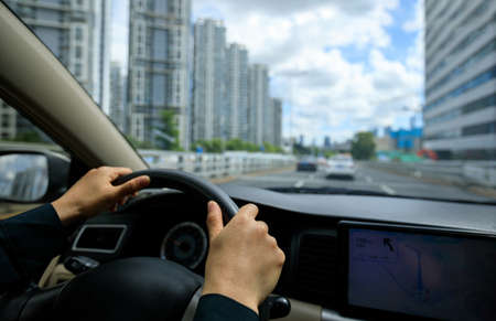 Driving car in modern cityの写真素材