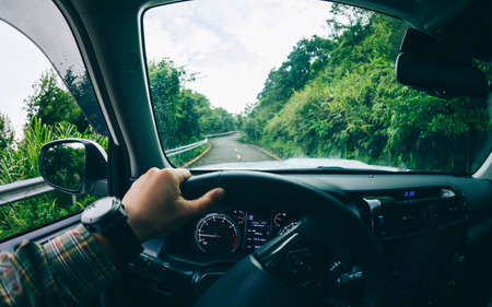 People driving car on mountain roadの写真素材
