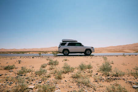 Driving White 4Runner TRD crossing in the desert road tripの写真素材