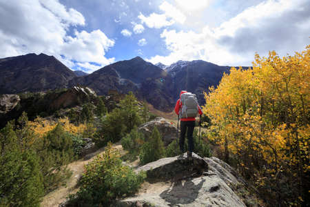 Backpacker hiking in high altitude winter mountainsの写真素材