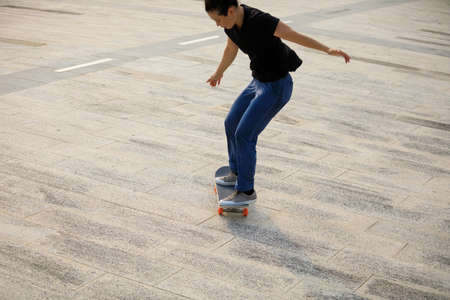 Skateboarder skateboarding outdoors in cityの写真素材
