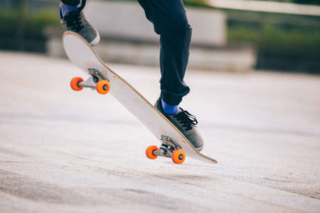 Skateboarder skateboarding outdoors in cityの写真素材