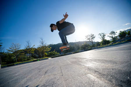 Skateboarder skateboarding outdoors in cityの写真素材