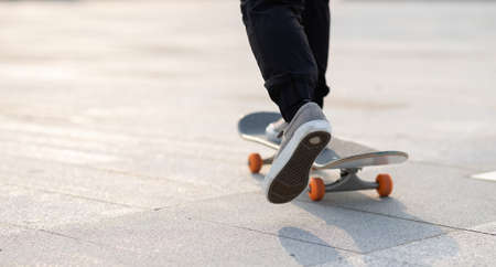 Skateboarder skateboarding outdoors in cityの写真素材