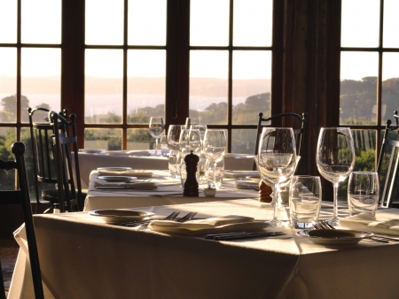 Gourmet restaurant tables await their guests in the afternoon light.の写真素材